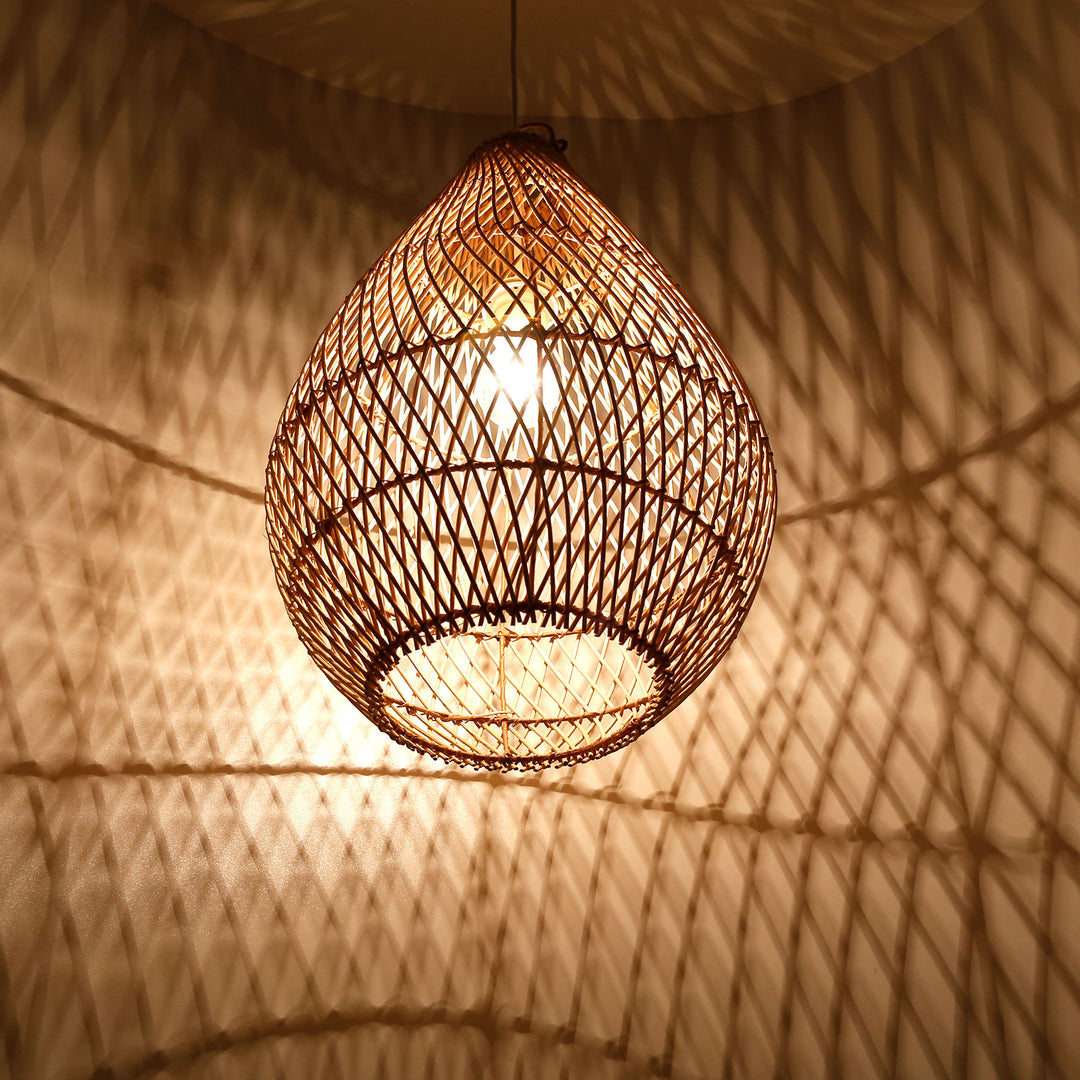 Drop-shaped ceiling light made of hand-woven rattan with warm light and decorative shadow play