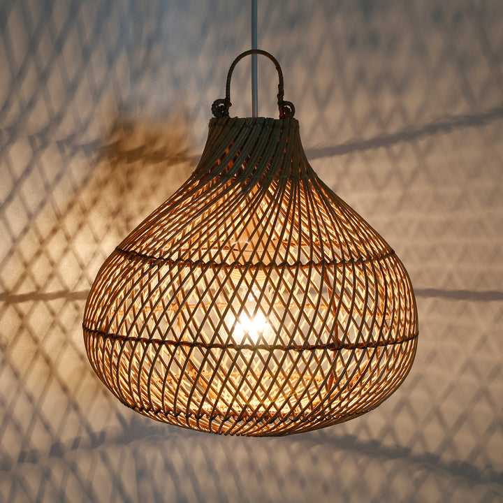 Handmade ceiling light made of rattan with a warm play of light on the wall, creating a cozy atmosphere