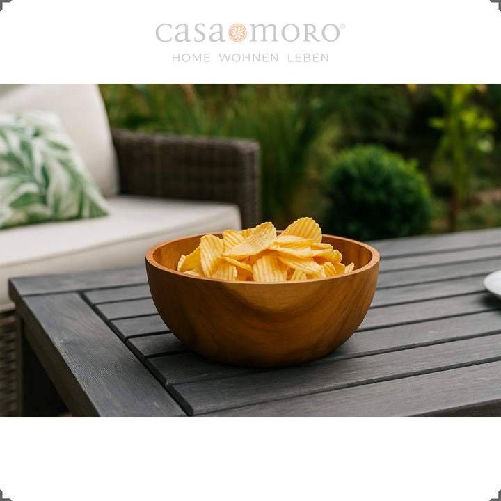 Decorative bowl with chips on a dark garden table