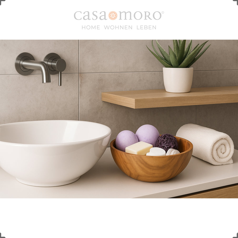Teak bowl as a bathroom decoration with soap and accessories