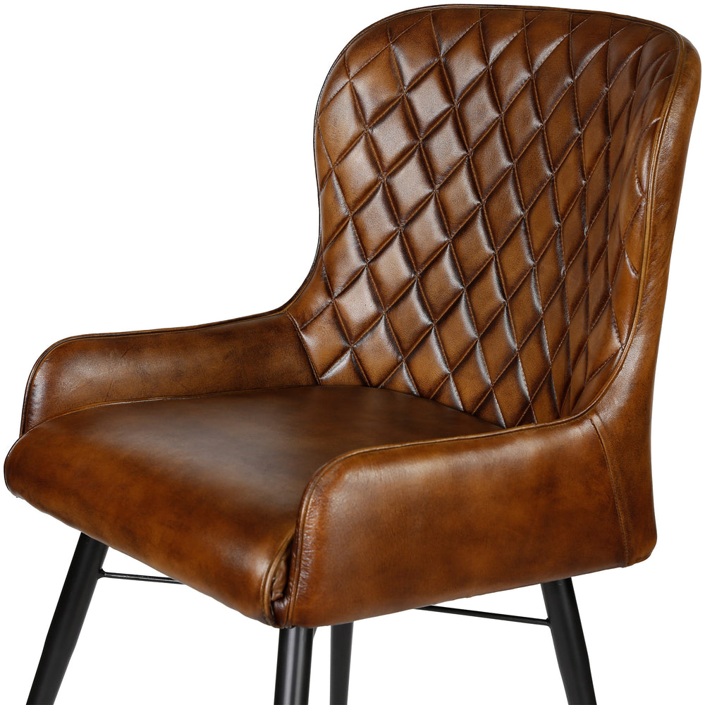 Leather chair in antique brown with fine quilting in the living room