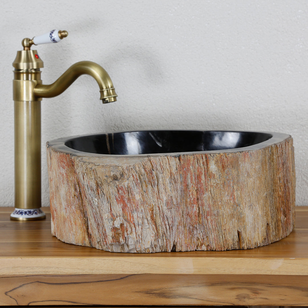 Washbasin Made of fossil wood with a striking external structure, round stone washbasin on a wooden top combined with brass fittings.