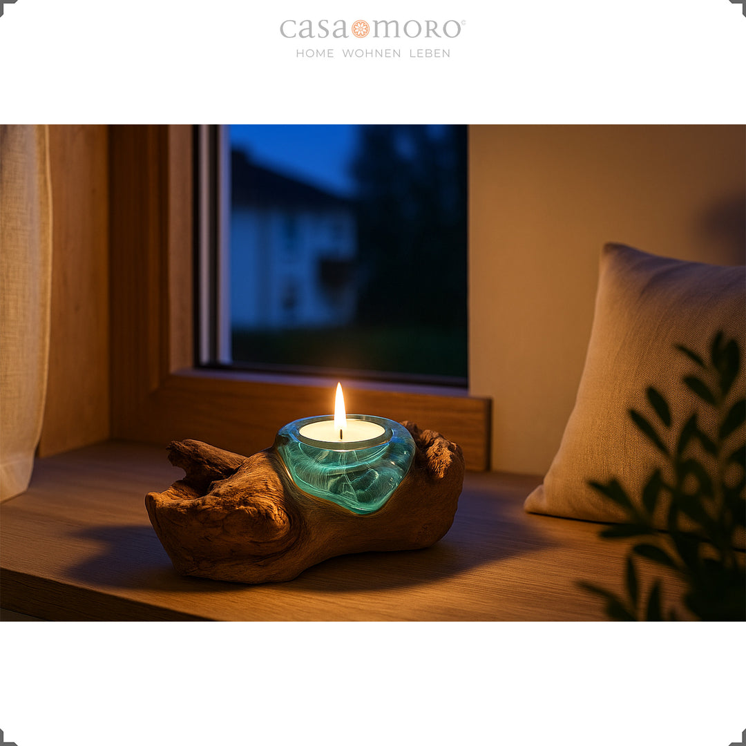 Tealight holder made of glass and burl wood on a windowsill, its warm light creates a gentle, calming atmosphere in the evening.