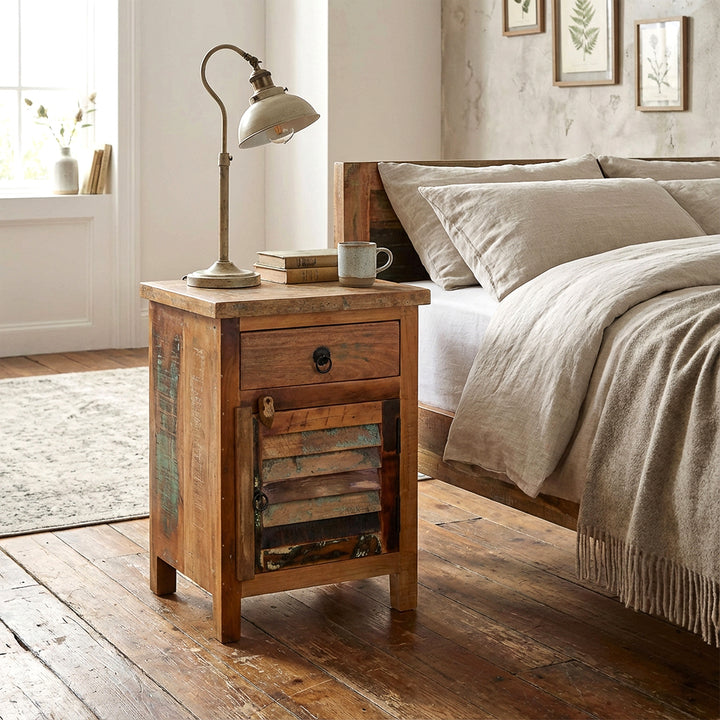 Solid wood chest of drawers as a bedside table in the bedroom, natural wood tones, warm light