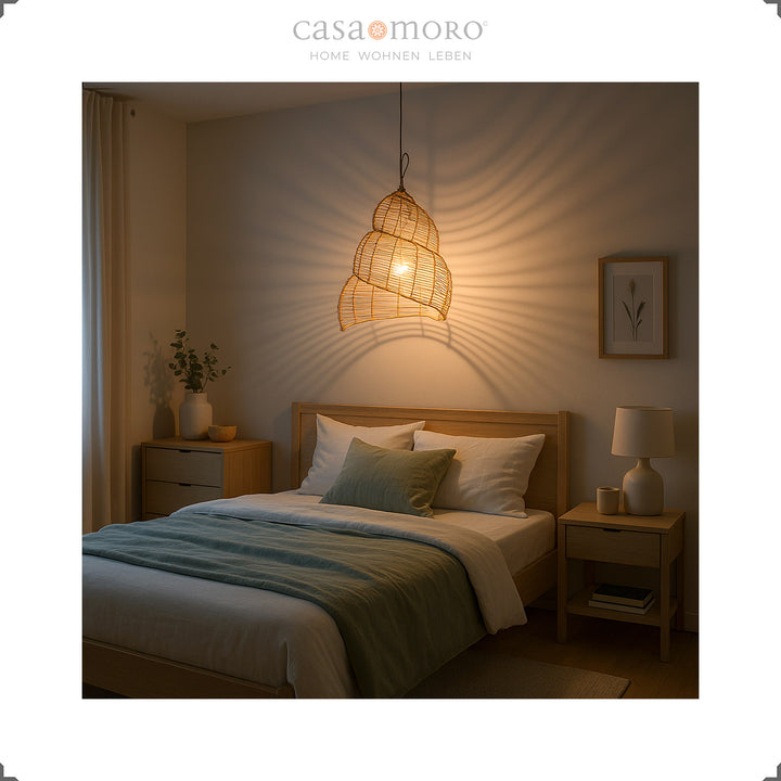 Spiral shaped rattan lamp as a ceiling light in the bedroom, creates warm light and a calm atmosphere
