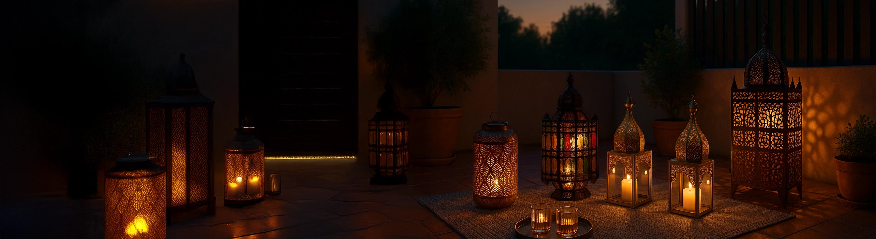 Moroccan lanterns – Various Moroccan lanterns at dusk on a terrace, lit with candles and oriental patterns on the floor and wall