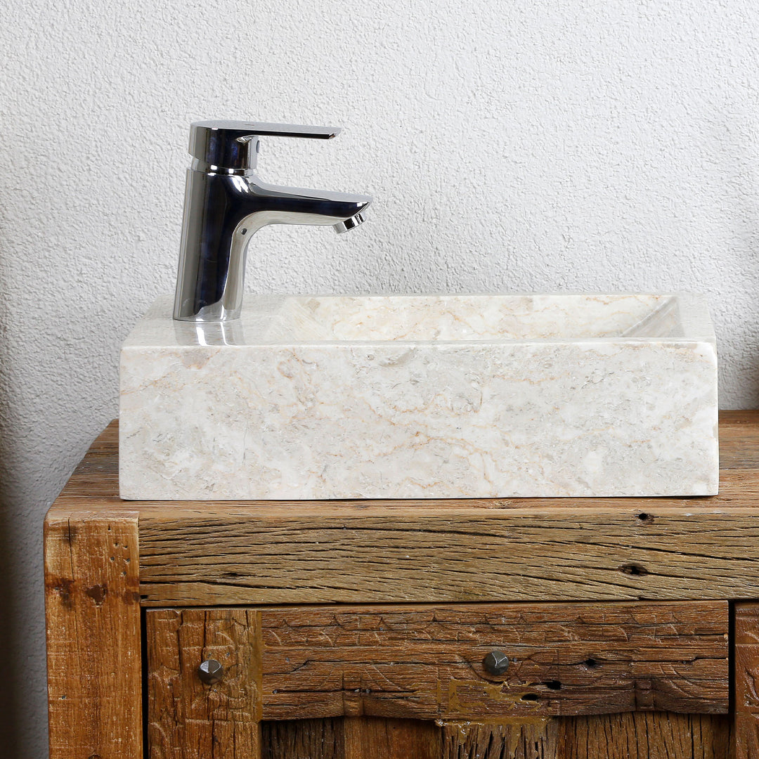 Rectangular Washbasin made of light natural stone as an attachment on a rustic wooden washbasin with chrome-plated fittings