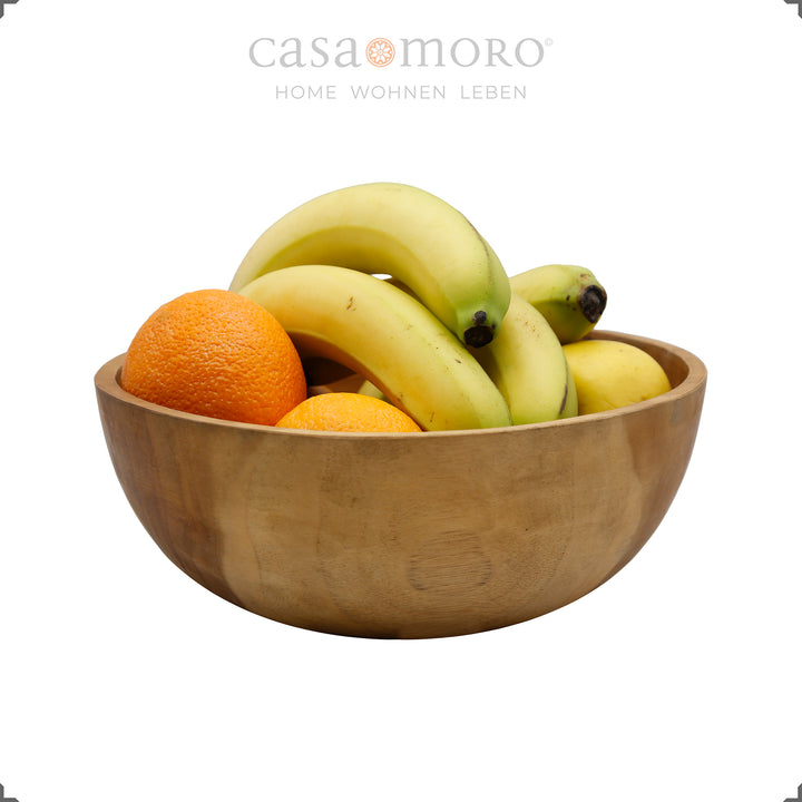 Fruit bowl made of natural teak wood filled with fruit