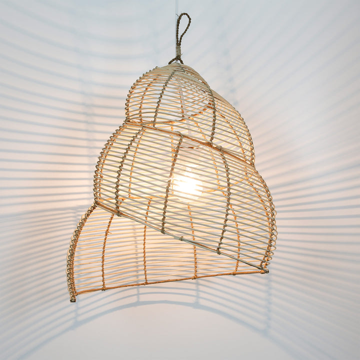 Spirally shaped rattan ceiling lamp with open weave and soft, natural play of light on the wall