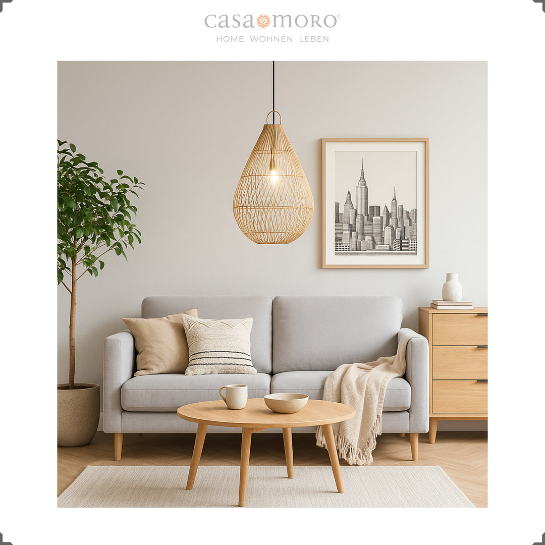 Handmade rattan lamp in teardrop shape as a hanging lamp in the living room, providing warm light and natural elegance