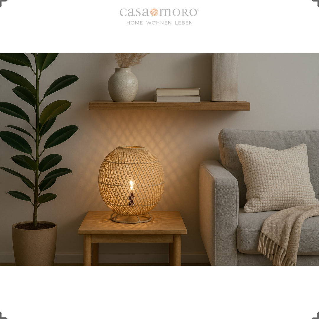 Round rattan lamp on wooden table next to sofa, soft light and natural furnishings