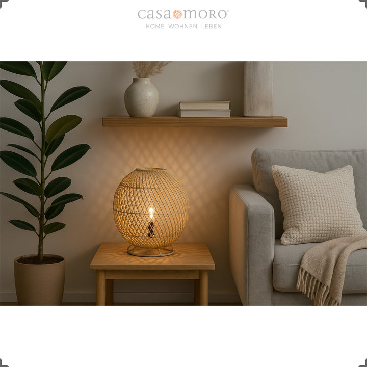 Round rattan lamp on wooden table next to sofa, soft light and natural furnishings