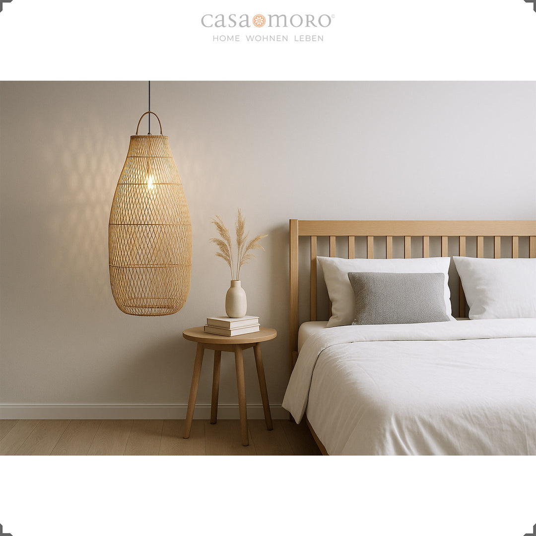 Large rattan lamp next to the bed in the bedroom, natural light and harmonious furnishings