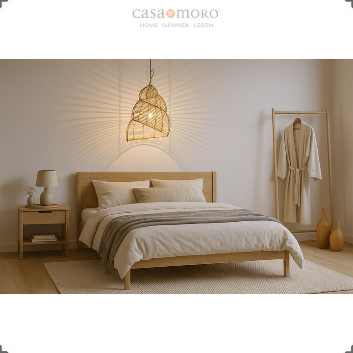 Spiral rattan lamp as a ceiling light in the bedroom, handmade with a warm play of light and shadow