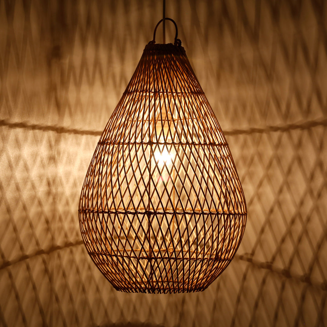Teardrop-shaped lampshade made of hand-woven rattan with fine weave and warm play of light