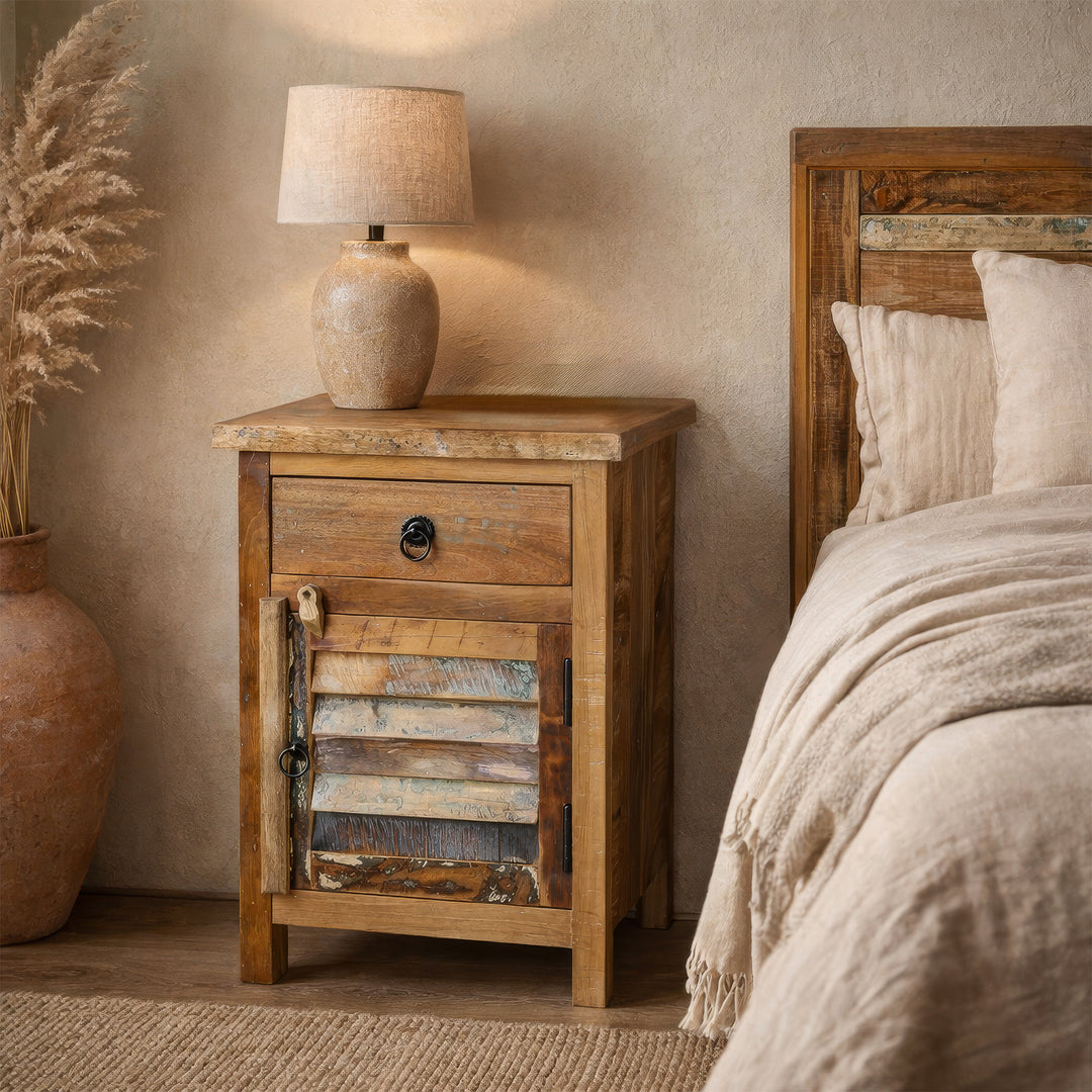 Solid wood chest of drawers as a bedside table in the bedroom, calm boho atmosphere, warm light