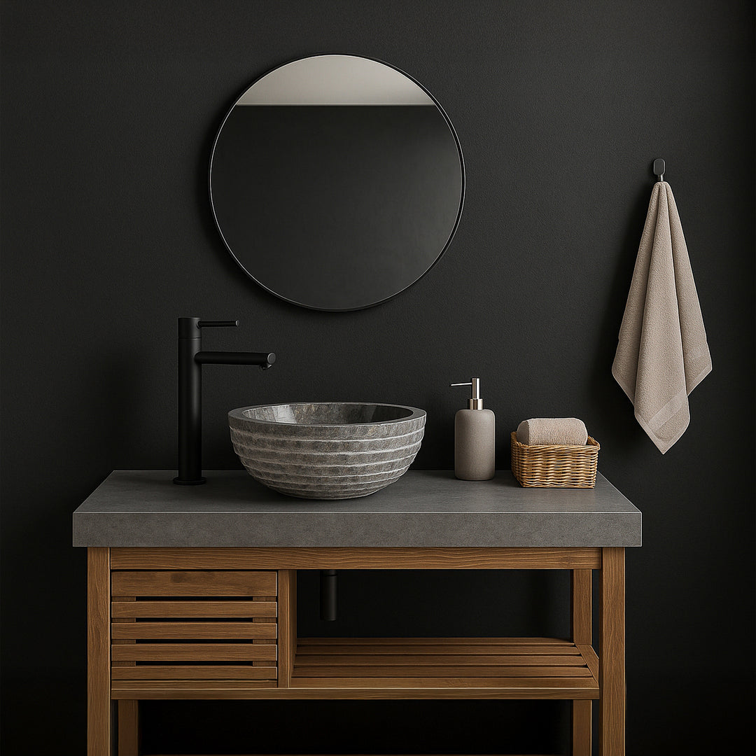 Gray stone washbasin as a countertop basin on the vanity unit, modern bathroom with dark walls, mirror and black fittings