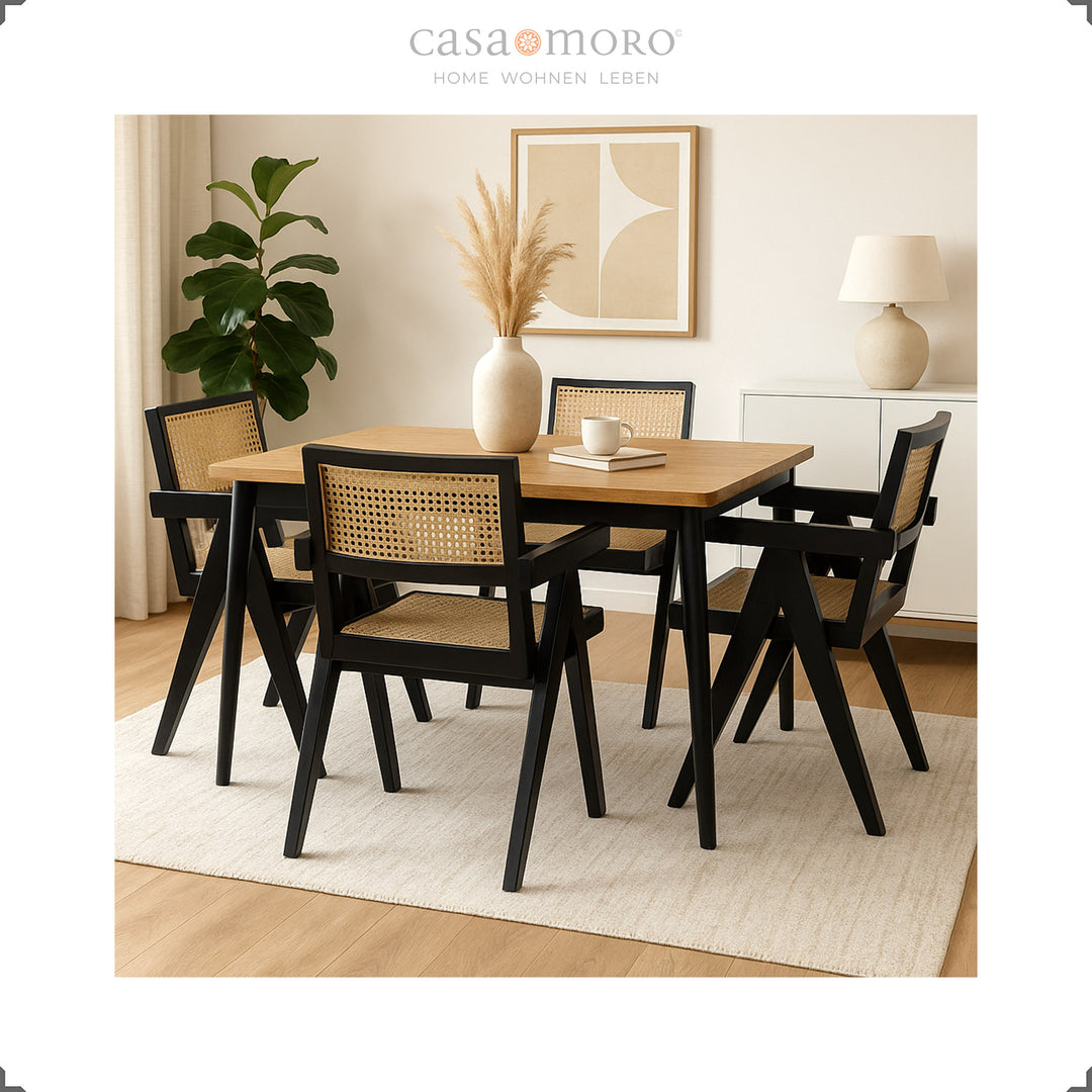 Black armchairs with Viennese weave around a wooden table, elegant dining room with warm natural tones
