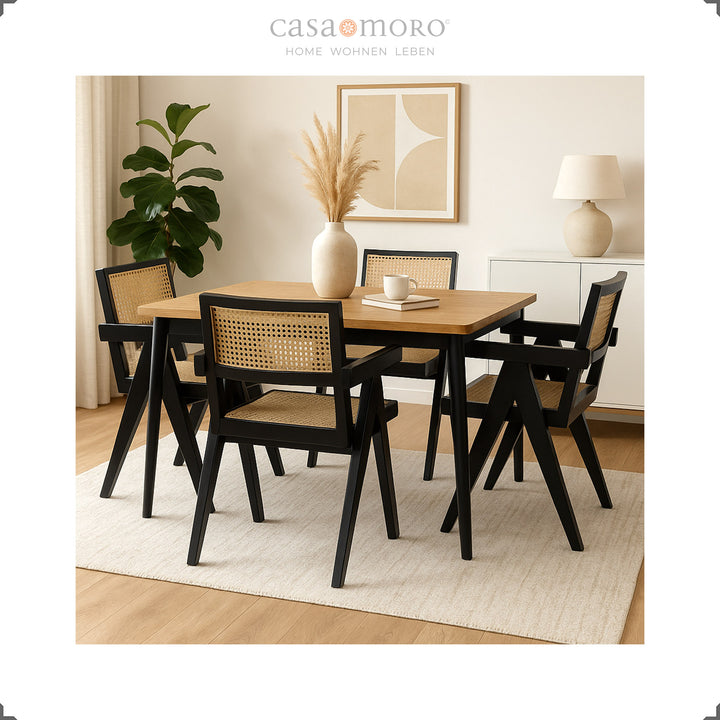 Black armchairs with Viennese weave around a wooden table, elegant dining room with warm natural tones