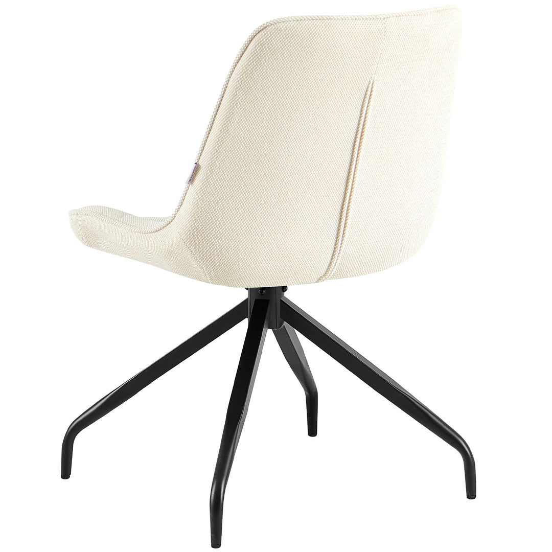 Rear view of the upholstered chair, which can be rotated 360° in beige with a black metal frame - elegant backrest with a fine structure and clear lines