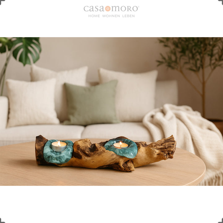 Tea light holder made of glass and burl wood on a chest of drawers, its warm light complements the simple, natural room design.