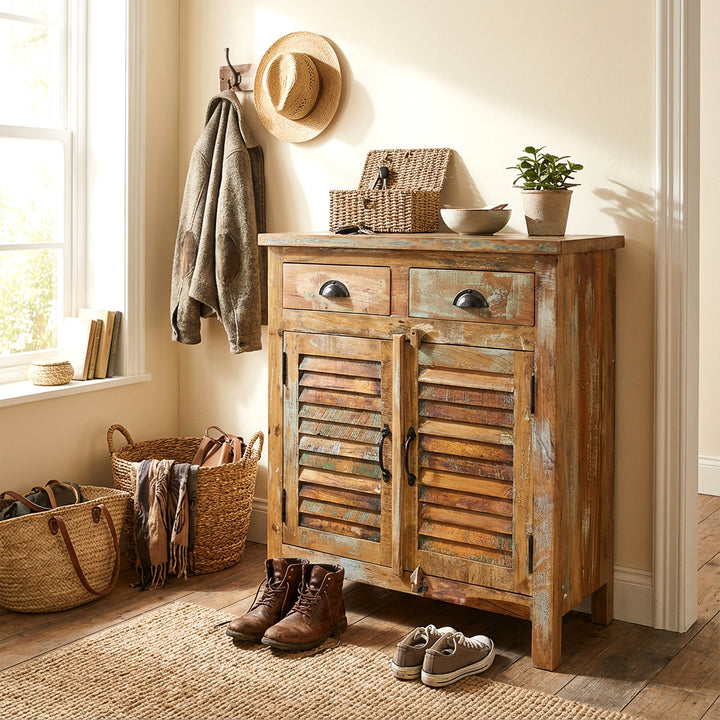 Solid wood highboard in the hallway with baskets and shoes, warm country house atmosphere