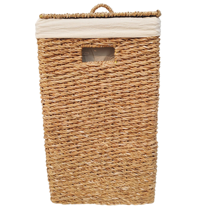 Rectangular laundry basket made of seagrass with a 90-liter capacity, a closed lid, a handle opening, and a light-colored fabric liner.