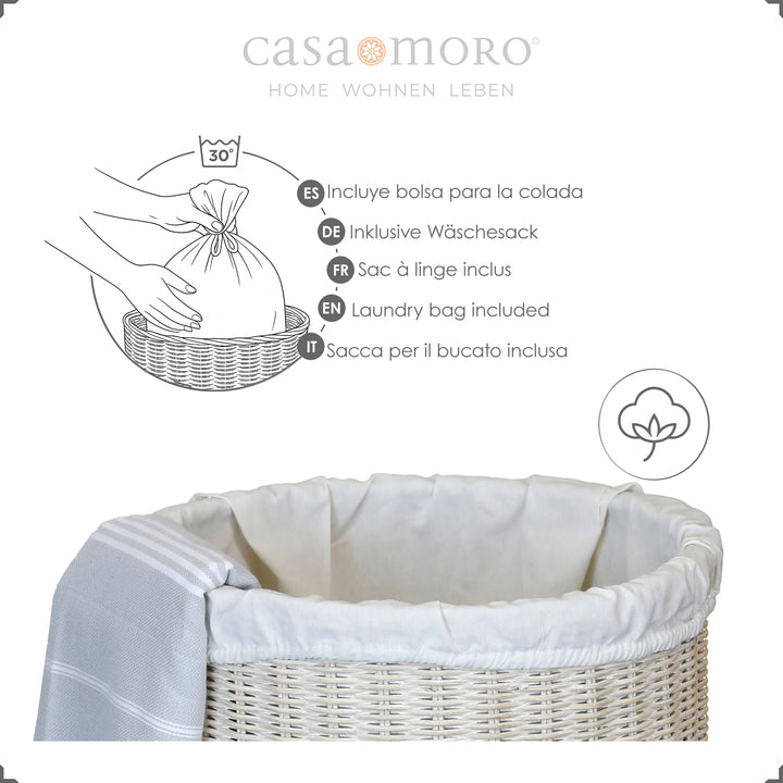 Whitewashed rattan laundry basket with light cotton insert, decorated with hammam towel