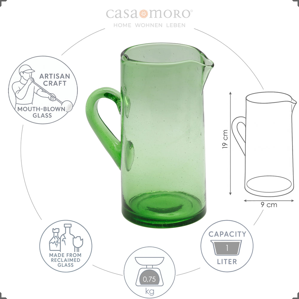 Green water carafe made of hand-blown glass with handle and spout