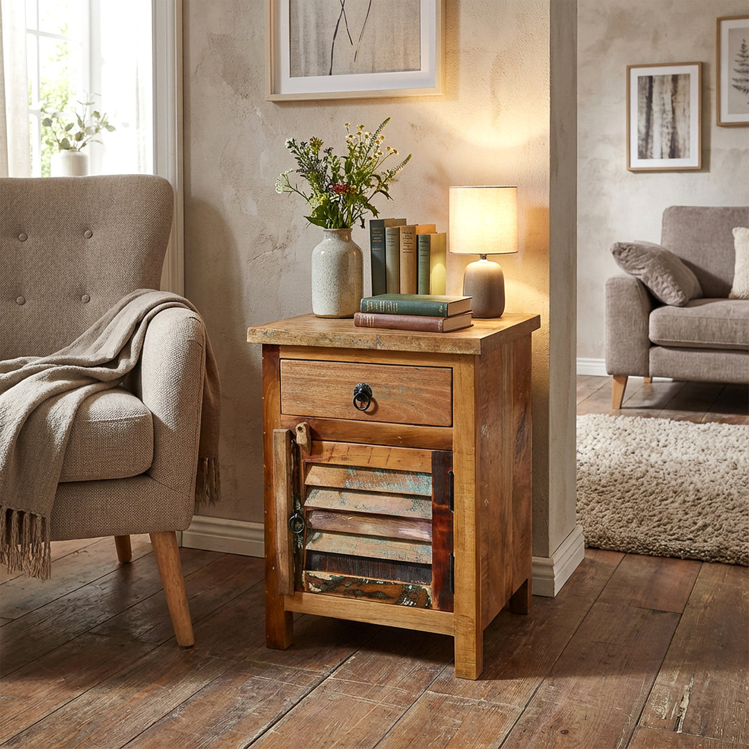 Solid wood chest of drawers in the living room with lamp and books, cozy living scene with warm light
